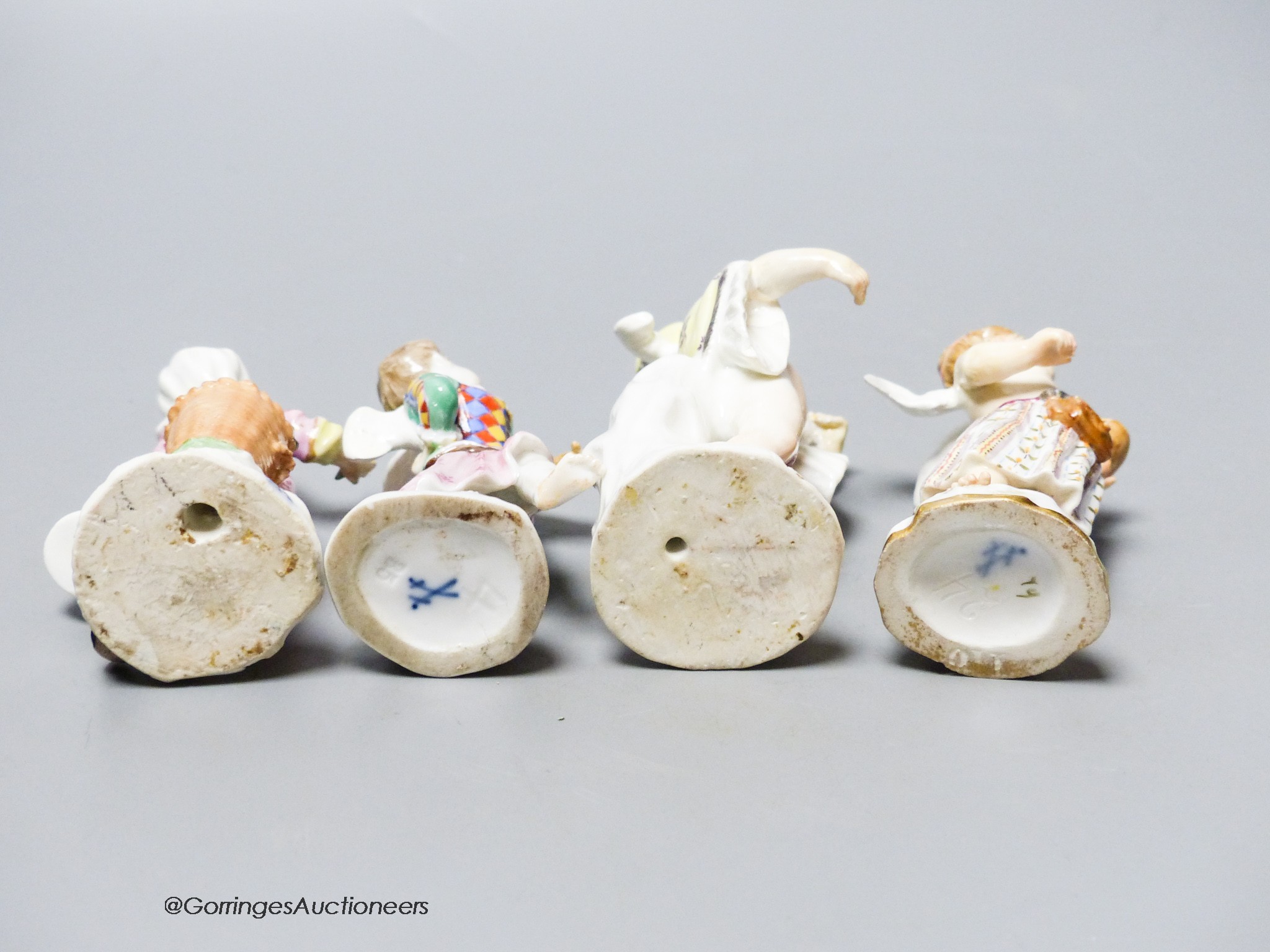 Two mid 18th century Meissen figures of Cupid in disguise and two similar 19th century figures, tallest 9cm